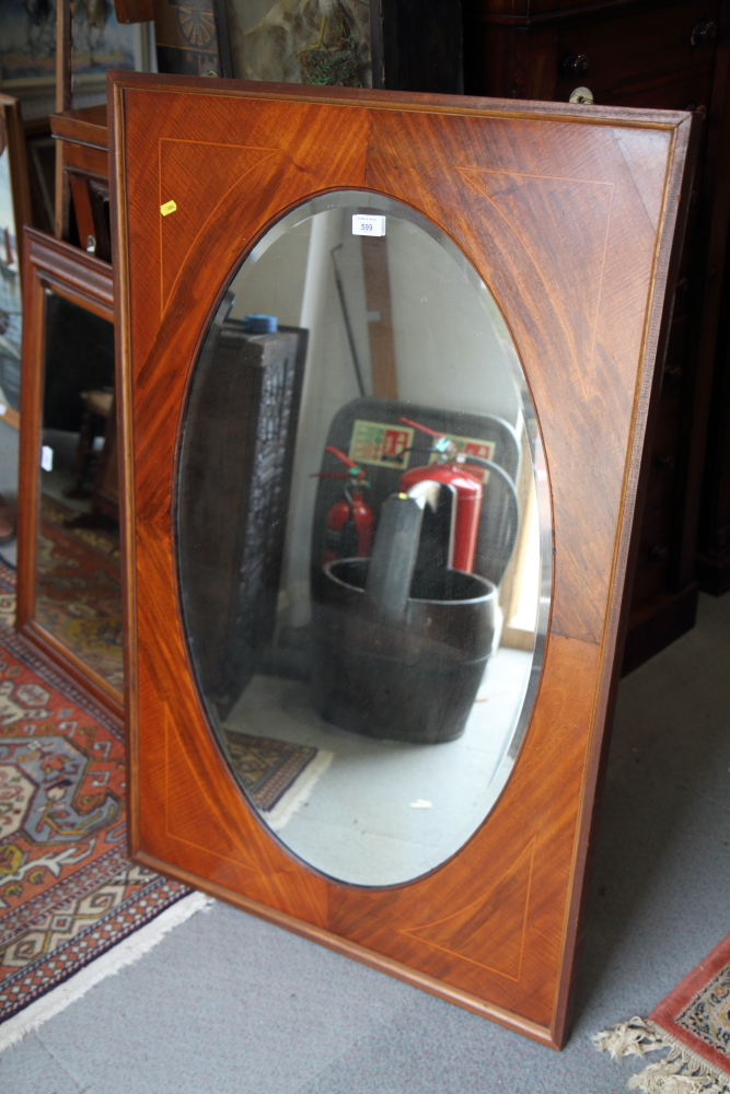 An Edwardian mahogany framed oval wall mirror, plate 21" x 36"