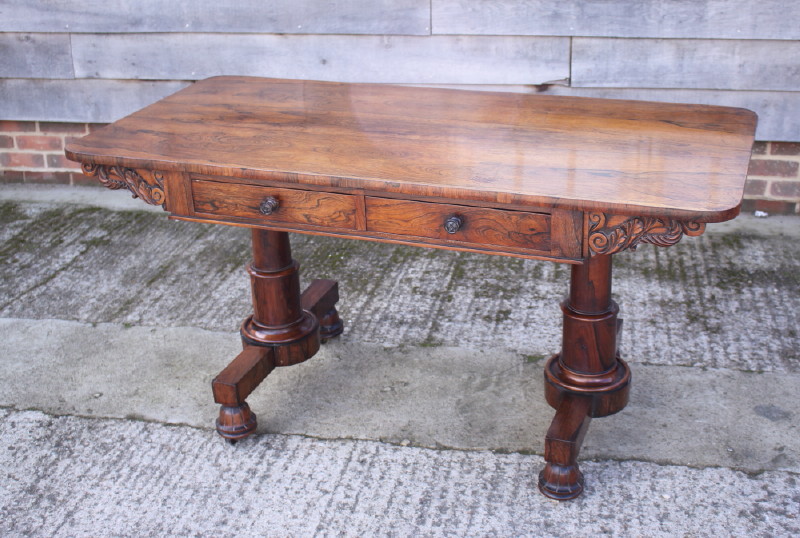 An early 19th century rosewood library table, fitted two real and two dummy frieze drawers, on
