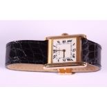 A gentleman's 18ct gold cased Cartier Tank wristwatch with white enamel dial and Roman numerals,