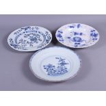 An 18th century Delft floral decorated plate, 9" dia, and two Chinese floral decorated blue and