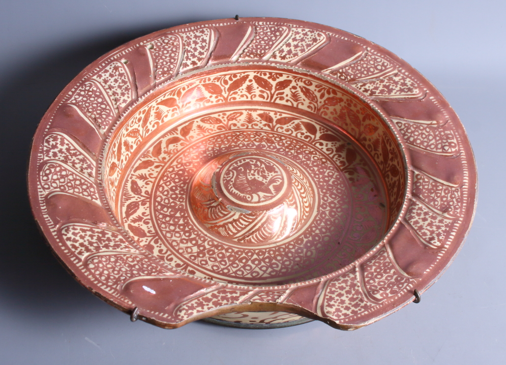 An early 18th century Hispano Moresque shaving bowl with traditional design, 14" dia (restorations)