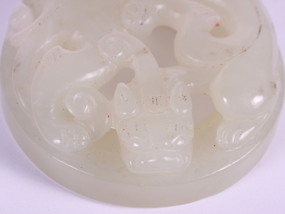 A Chinese carved celadon jade roundel decorated Kylin, 2" dia - Image 3 of 4