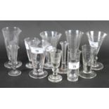 A collection of assorted conical glass medicine measuring glasses