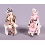 A pair of late 19th century Continental porcelain figures, seated musician and a woman, in period