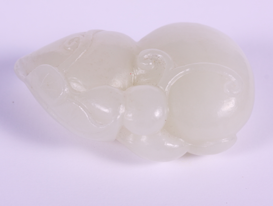 A Chinese pale celadon jade carving of a double gourd, 2 1/2" long