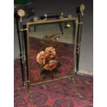 An Arts & Crafts brass and floral painted mirror panel firescreen