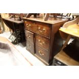 A Georgian mahogany side cabinet, fitted one deep drawer and faux drawers enclosing shallow drawers,