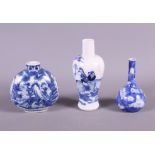 A 19th century Chinese blue and white porcelain snuff bottle with landscape decoration and two