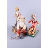 A pull-along teddy on a tricycle, a figure of Santa Claus and a figure of Johnny Walker (some