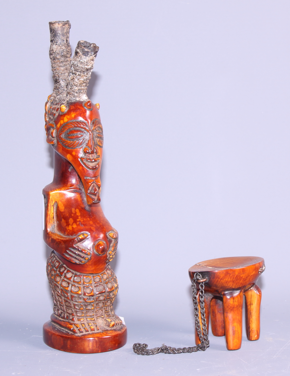 A carved ivory pipe, formed as figure of a standing man, 7 1/2" high, and an ivory four legged stool