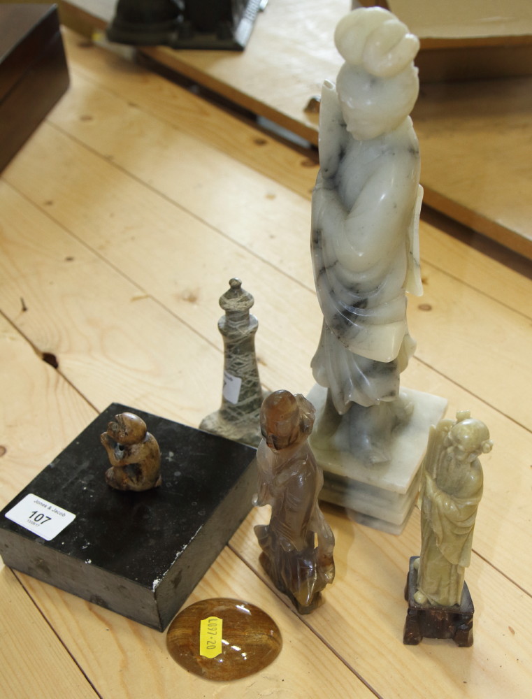 Three Chinese carved hardstone figures, various, a serpentine stone lighthouse paperweight and a