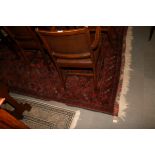 A Bokhara carpet with eight rows of small guls on a dark red ground and numerous border stripes,