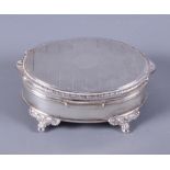 An oval silver trinket box with engine turned decoration to hinged lid