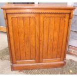 A late 19th century Aesthetic oak cupboard, fitted adjustable shelves enclosed two plain bordered