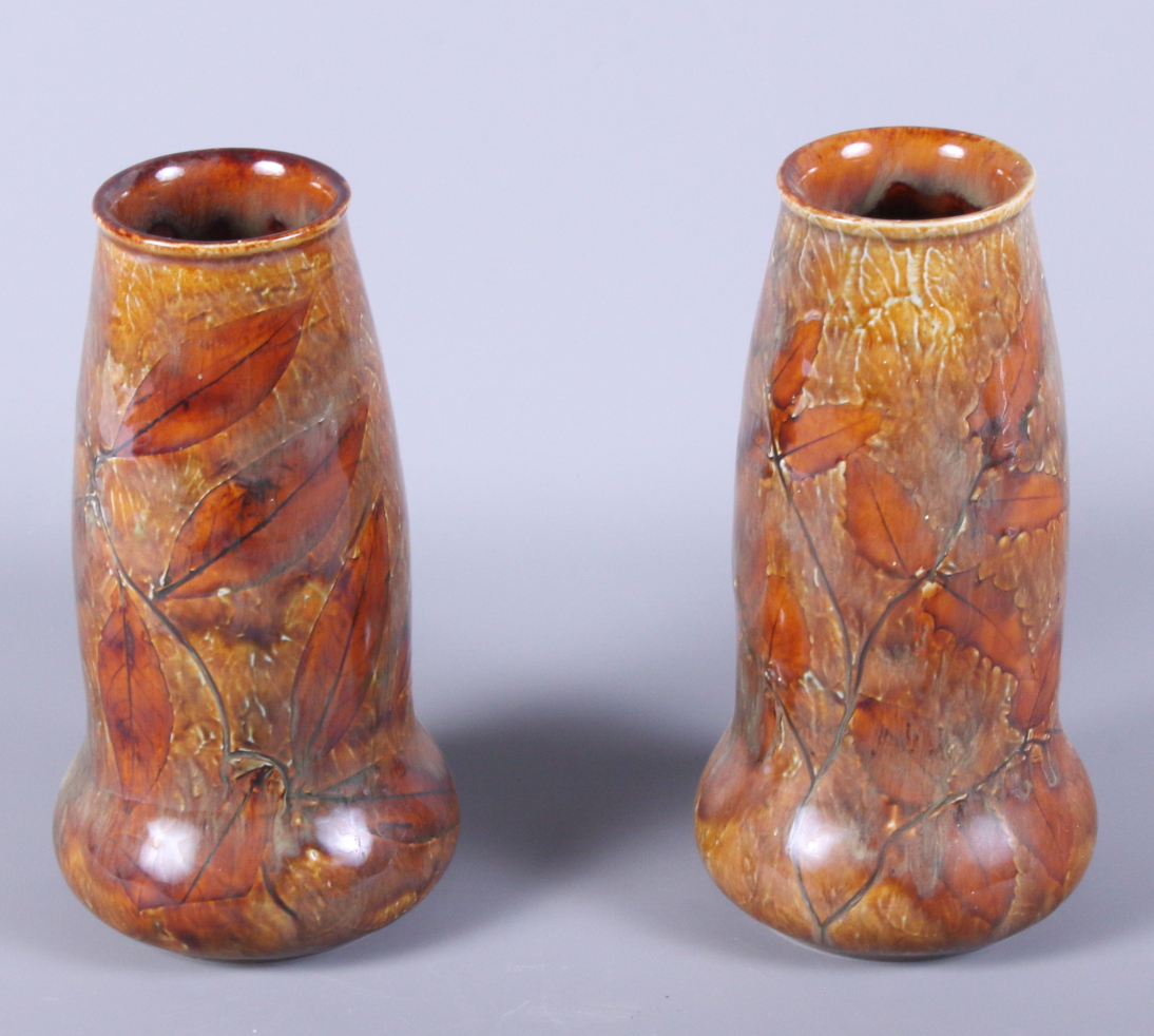 A pair of early 20th century Royal Doulton stoneware vases, "Autumn Leaves", shape number 5746,