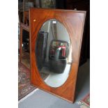 An Edwardian mahogany framed oval wall mirror, plate 21" x 36"