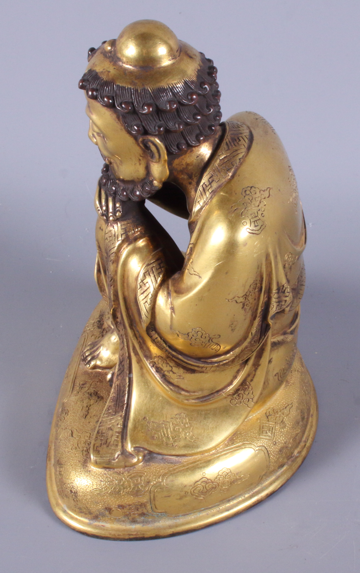 A late 19th century Chinese gilded figure of a crouching bearded man, engraved various Buddhist - Image 2 of 5