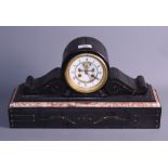 A late 19th century slate and marble drum cased mantel clock with white enamel dial and eight-day