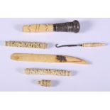 A 19th century Chinese carved ivory needle case, another similar (lacking lid), a silver mounted