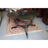A late 19th century ebonised and gilt shaped marble-top table, on barley twist castored supports,
