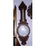 A Dolland aneroid barometer, in carved oak case