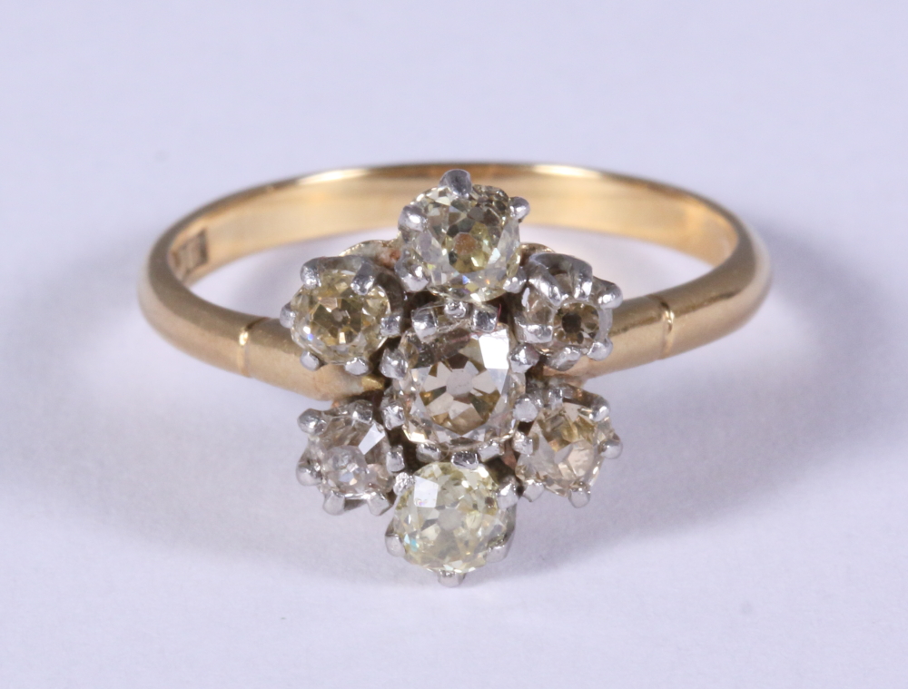 An 18ct gold and diamond seven stone cluster ring, size O