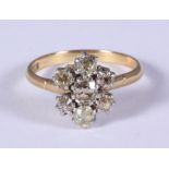 An 18ct gold and diamond seven stone cluster ring, size O