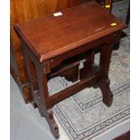 An early 20th century mahogany organ stool with pierced sides