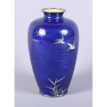 A 1920s Japanese cloisonne baluster vase decorated with three birds in flight on a blue scale