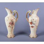 A matched pair of late Victorian Royal Worcester blush ivory porcelain ewers, shape number 1587,