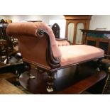 A late 19th century carved walnut showframe chaise longue, upholstered in a pink velour, on turned