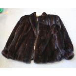 A dark brown, possibly mink, half length jacket