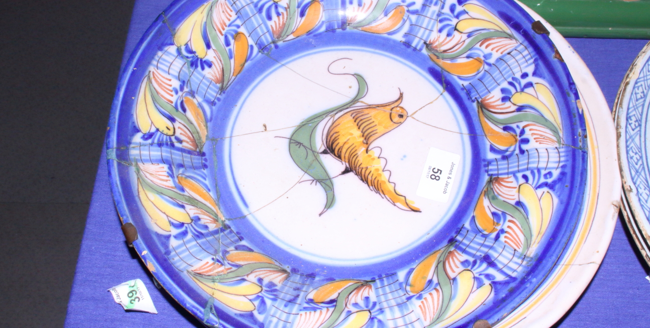 An 18th century Continental polychrome Delftware dish with bird and fruit decoration, 12 1/4" dia (