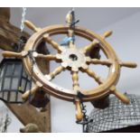 A four-light ship's wheel pendant centre light and a ship in a glass bottle