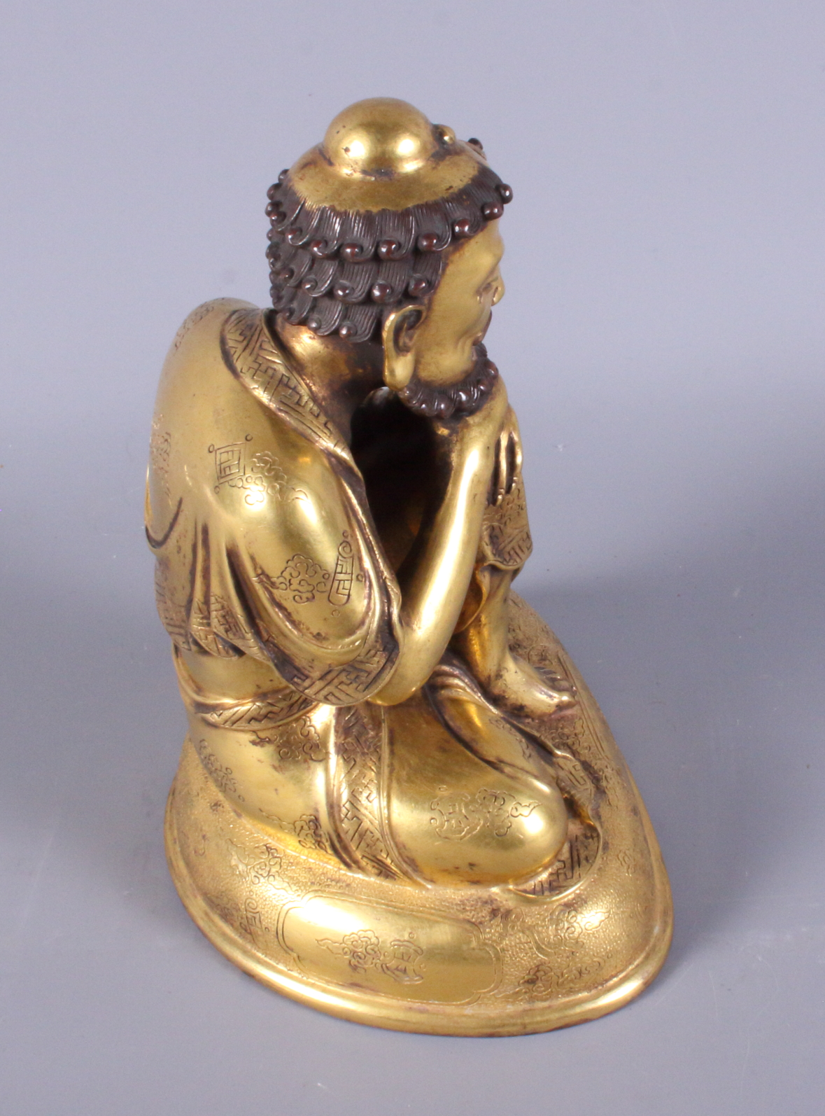 A late 19th century Chinese gilded figure of a crouching bearded man, engraved various Buddhist - Image 4 of 5