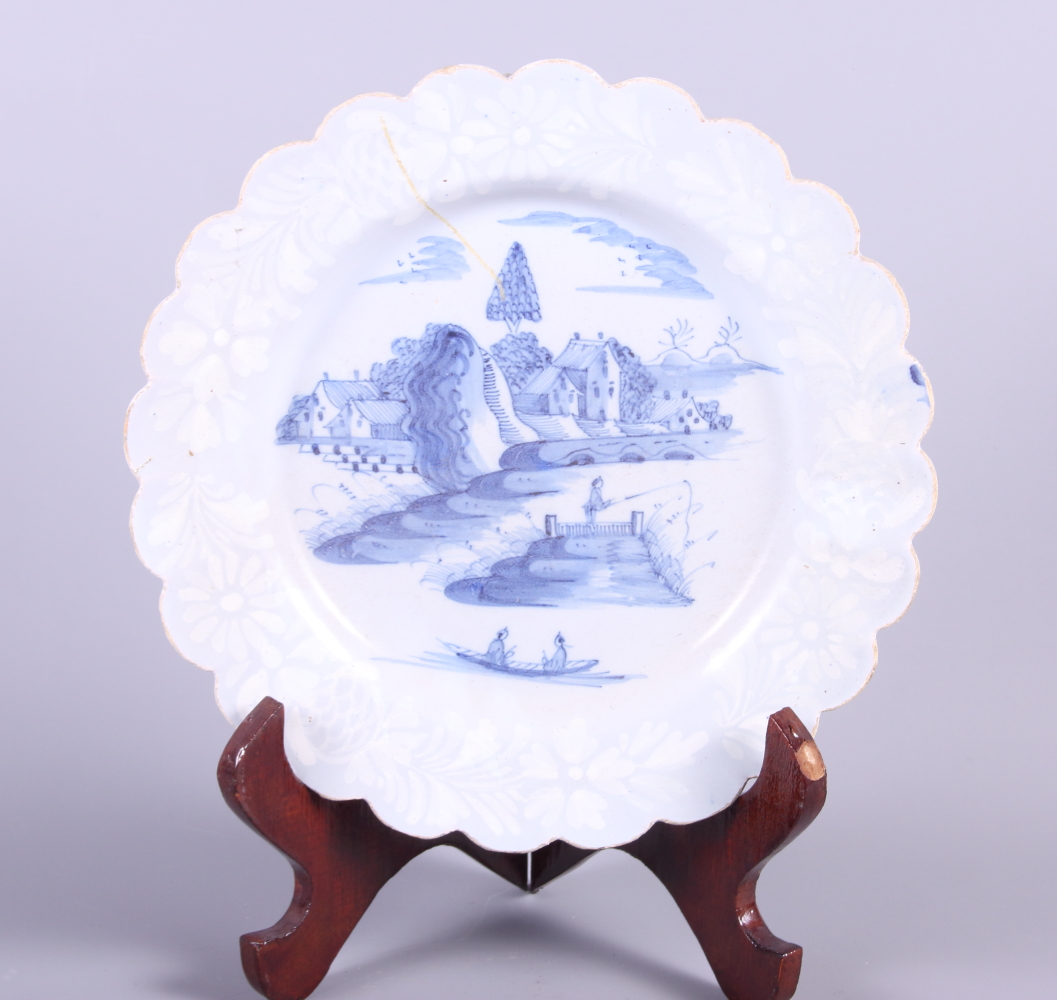 An early 18th century Bristol bianca sopra plate with waived rim and landscape with fisherman