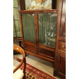 A late 19th century Continental oak display cabinet enclosed two glazed doors, on square taper