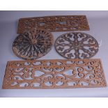 A pair of decorative Victorian pierced cast iron panels and two similar circular panels