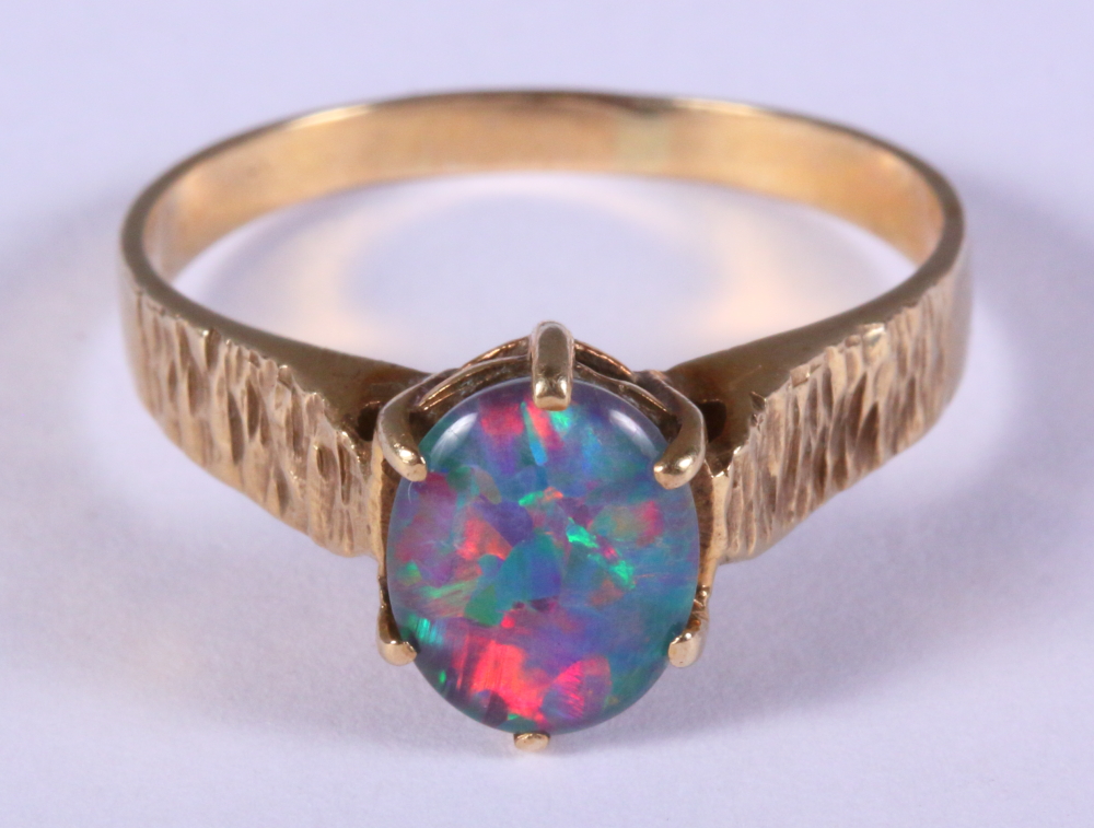 A 9ct gold and opal single stone dress ring, size R