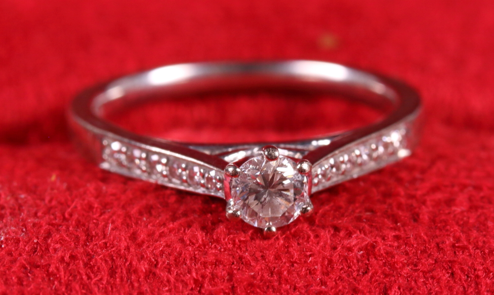 A Canadian Ice 18ct white gold and diamond engagement ring, central stone approx 0.15ct, flanked six