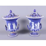 A pair of late Victorian blue and white Wedgwood jasperware (cameo ware) two-handled urns, each with
