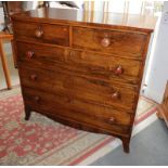 An early 19th century rosewood chest of two short and three long drawers, on cut away bracket