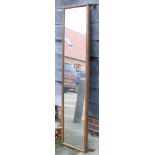 A carved and ebonised pierced frame wall mirror, plate 17 1/2" x 21", and an oak framed slip mirror,