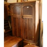 An oak framed part bedroom suite with decorative burr wood panels, comprising wardrobe, tallboy,