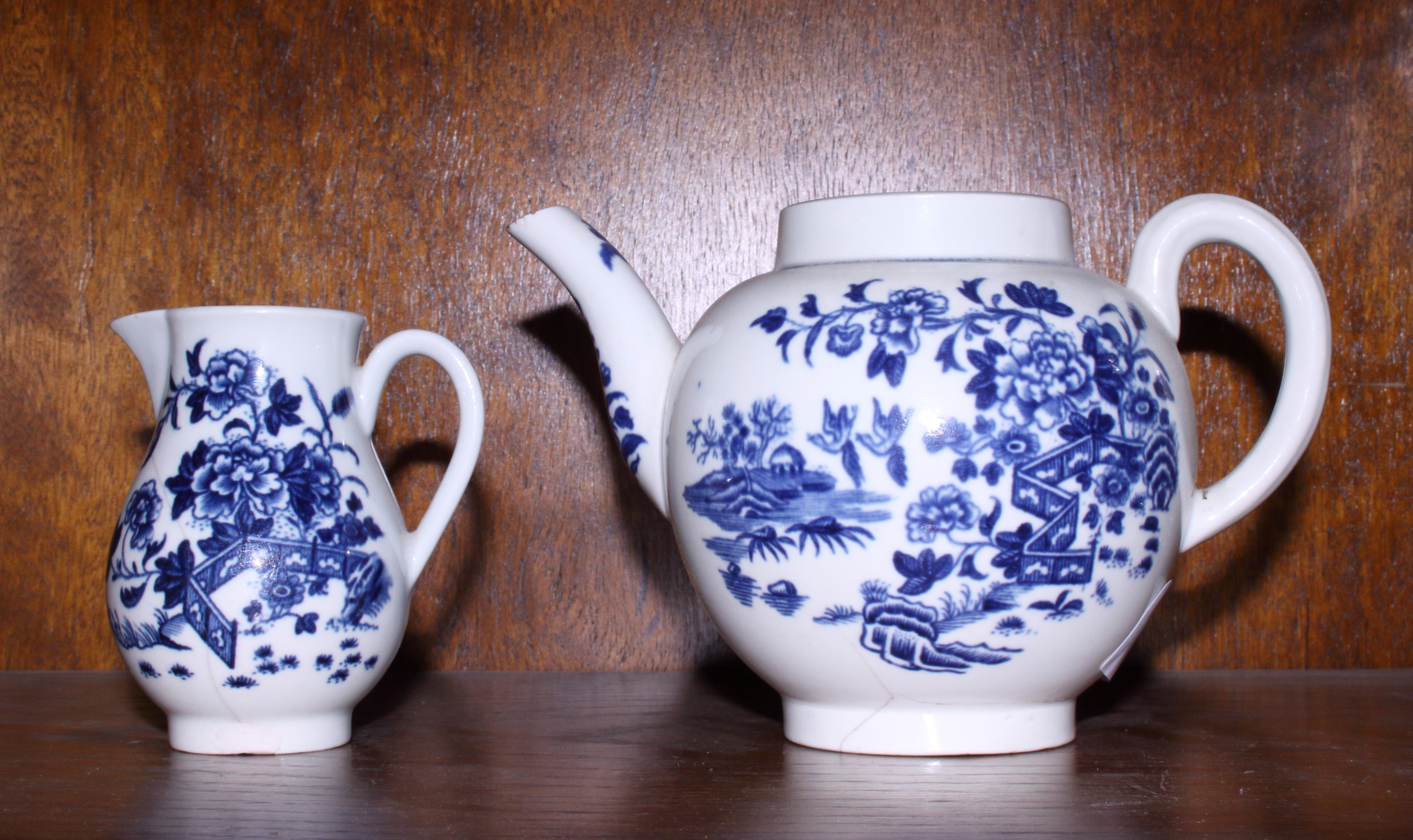A late 18th century Worcester porcelain "Fence" pattern teapot, 6" high, and a similar milk jug, 3