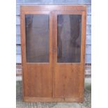 A mid 20th century plain oak bookcase enclosed part glazed doors, 34" wide