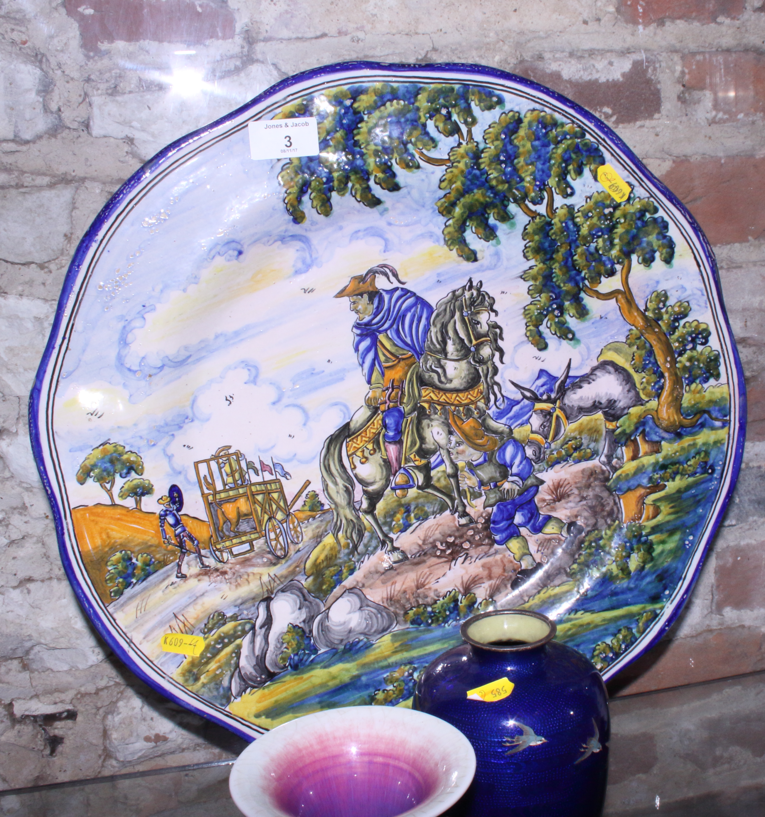 A Spanish majolica charger with Don Quixote and Sancho Panzer decoration, 18" dia