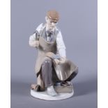 A Lladro ornament of a cobbler art work, 10" high, and a Lladro porcelain model 'Lamplighter'