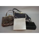 A mock crocodile handbag, two black evening bags and one other evening bag