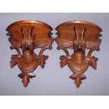 A pair of 19th century Black Forest wall brackets, each carved with the head of a deer, 7 3/4" x 6